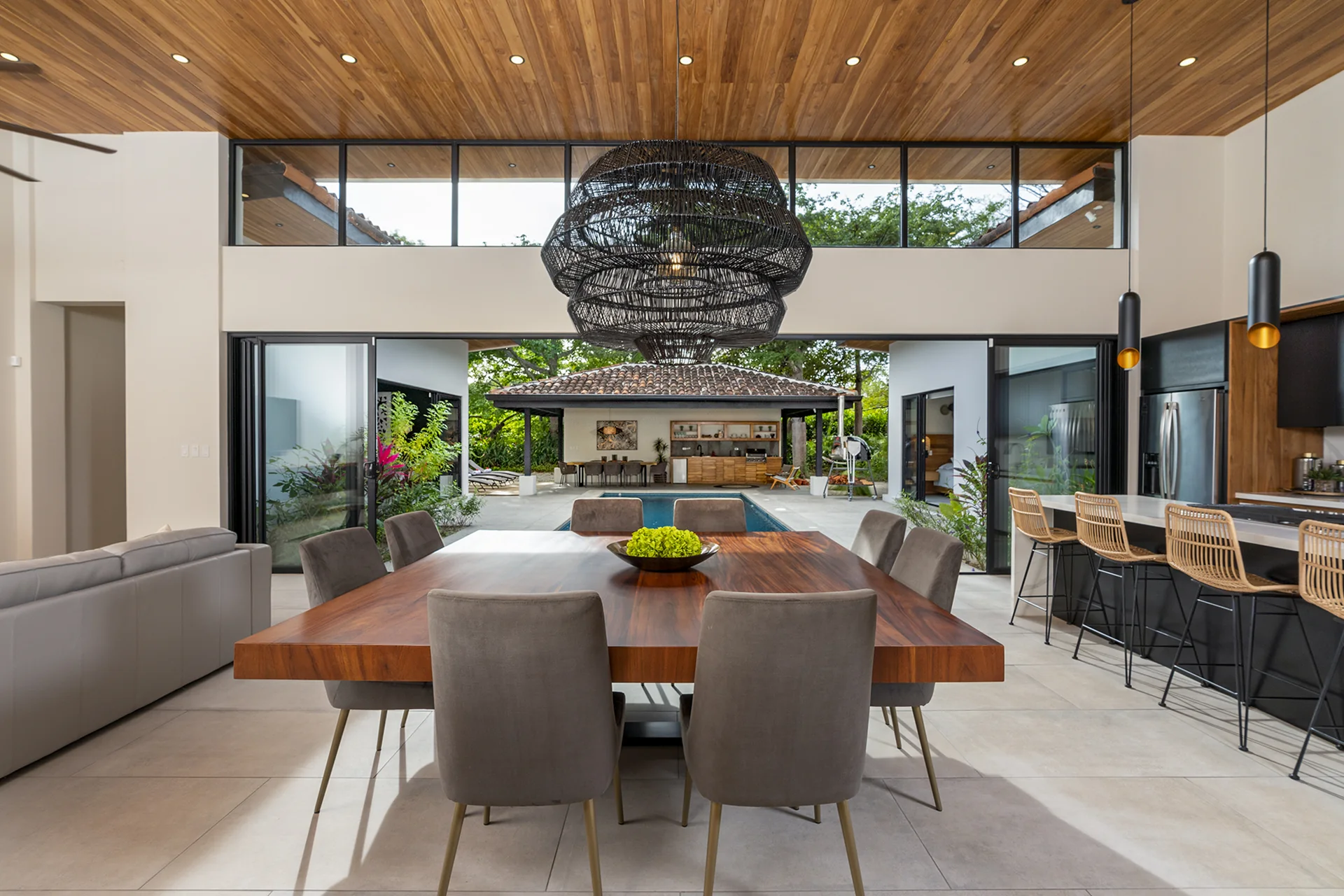 Open-concept living, dining and kitchen opening onto the pool at Hacienda Pinilla